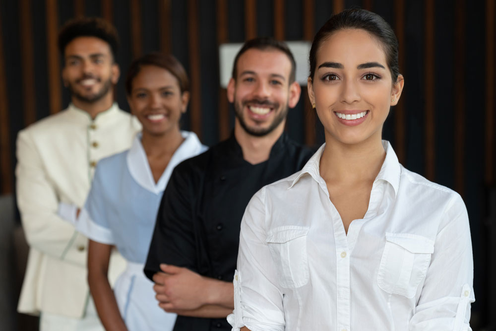 Hotel Employees smiling waiting to help the customer